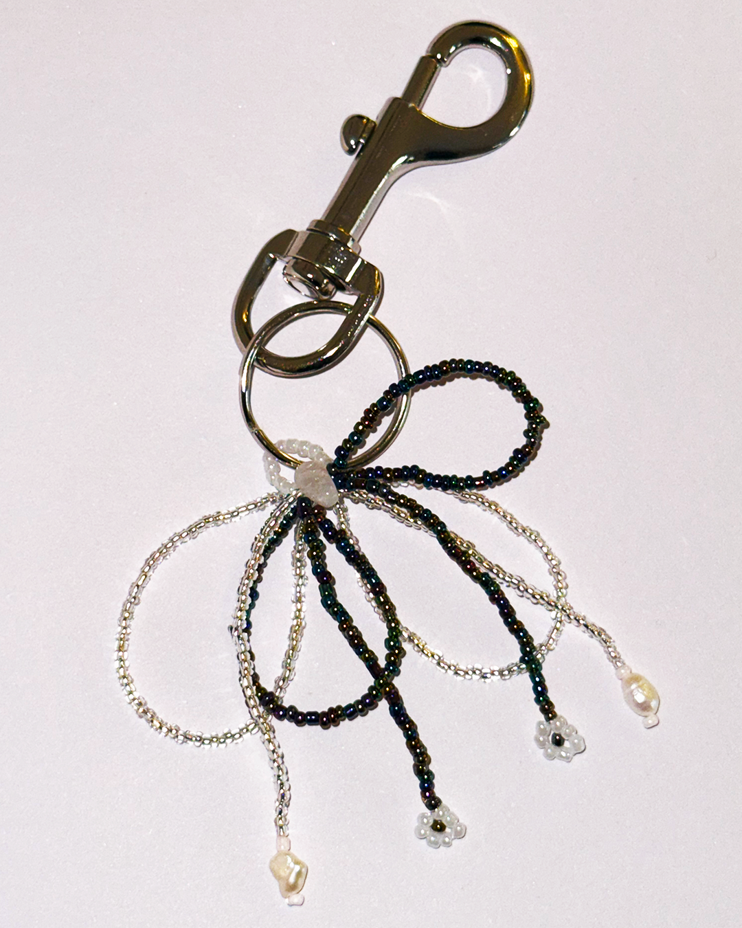 Keychain with beaded bow and metal clasp on a white background