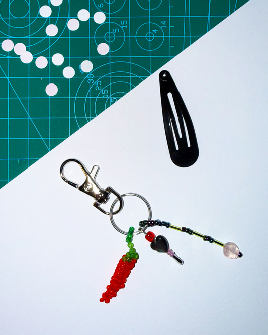 Chili keychain with a pin and a small black mother-of-pearl heart