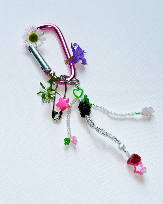 Beaded keychain with colorful charms on a white background