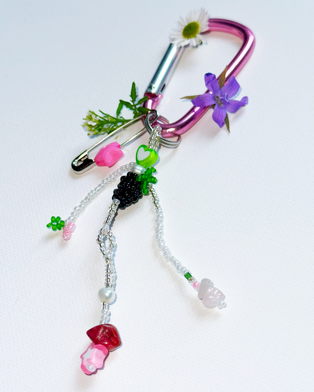 Beaded keychain with colorful charms on a white background