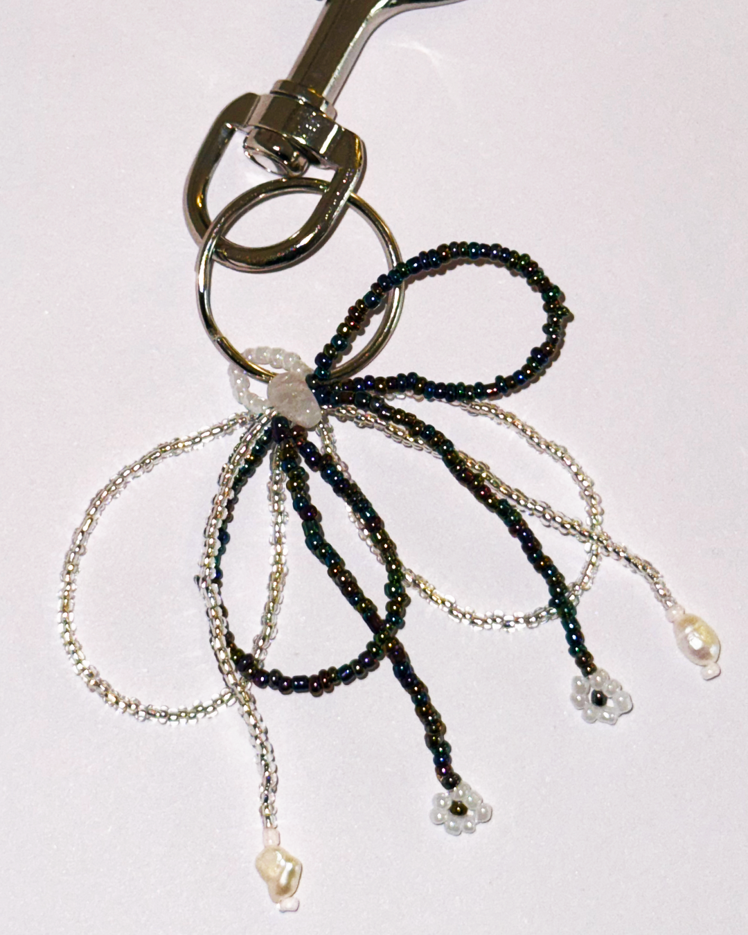 Keychain with beaded bow and metal clasp on a white background