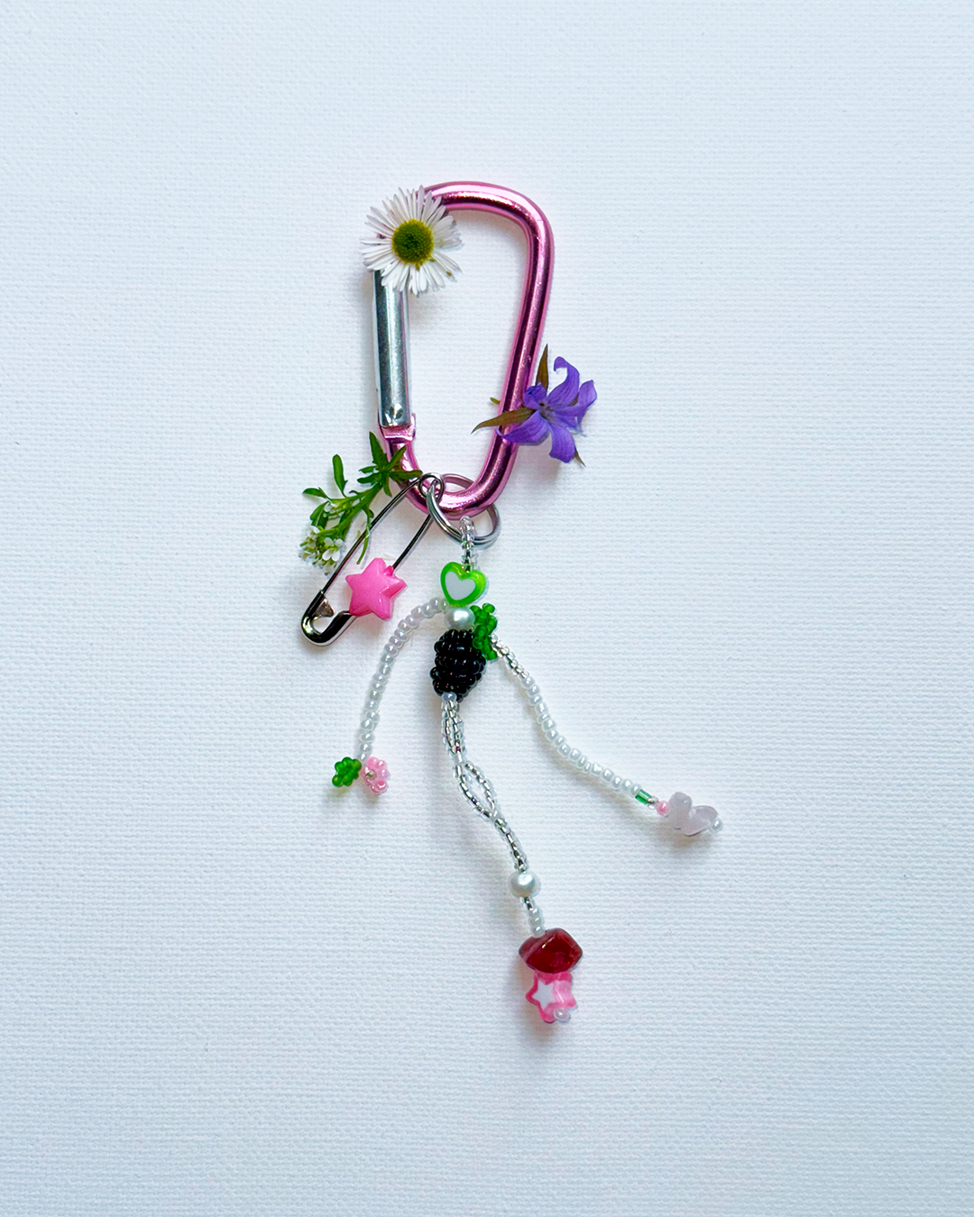 Colorful keychain with various charms on a light blue background