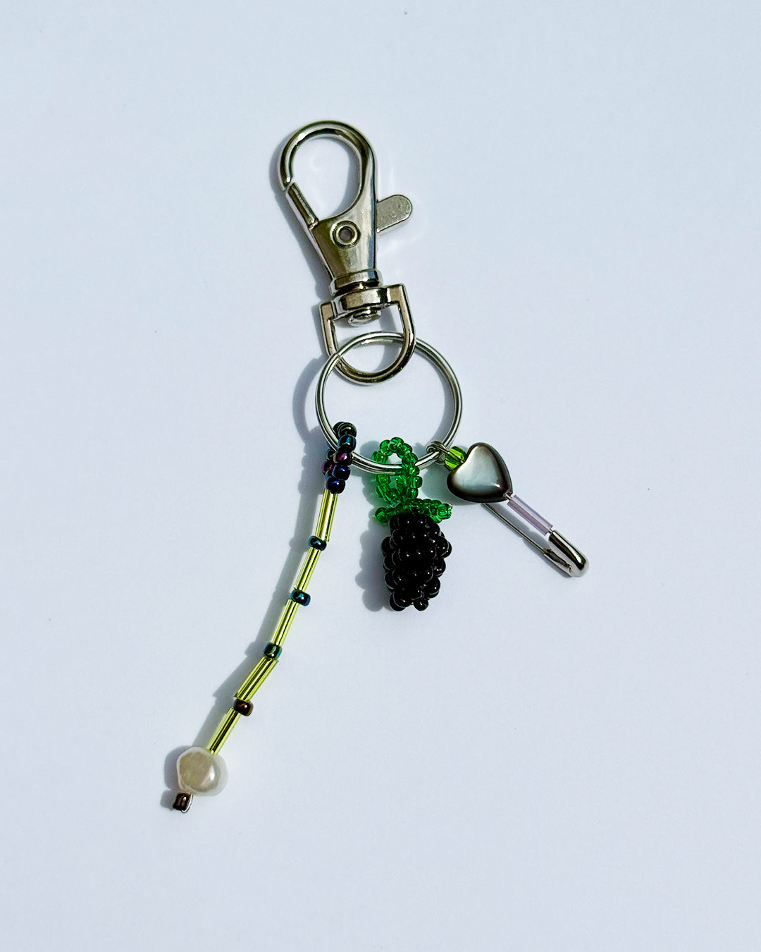 Blackberry keychain with a pin and a small black mother-of-pearl heart