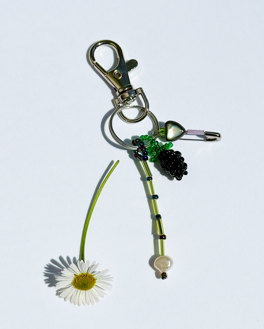 Blackberry keychain with a pin and a small black mother-of-pearl heart