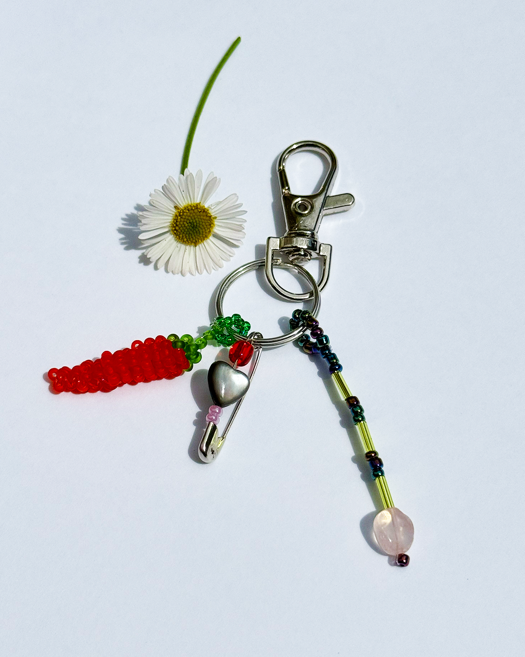 Chili keychain with a pin and a small black mother-of-pearl heart
