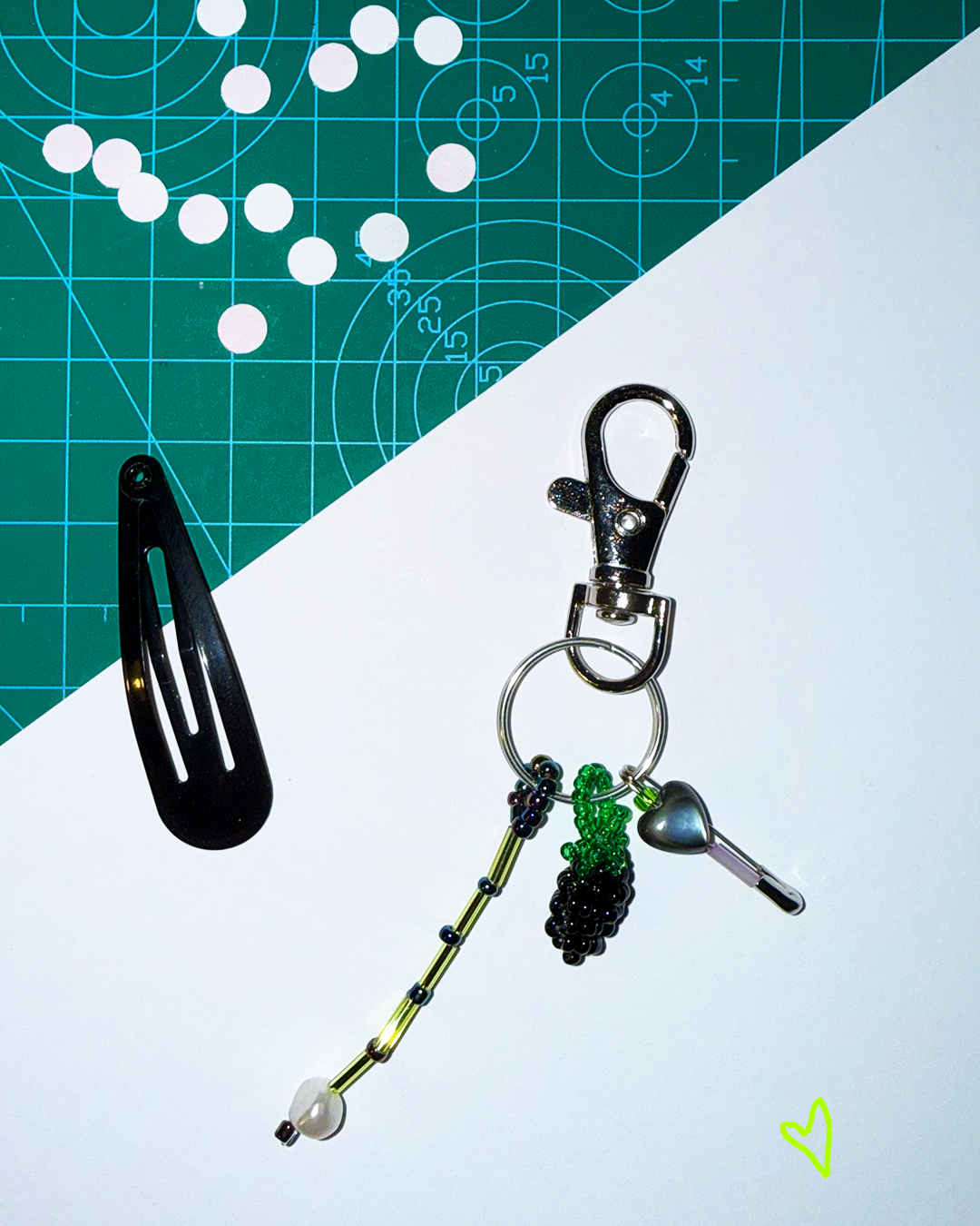 Blackberry keychain with a pin and a small black mother-of-pearl heart