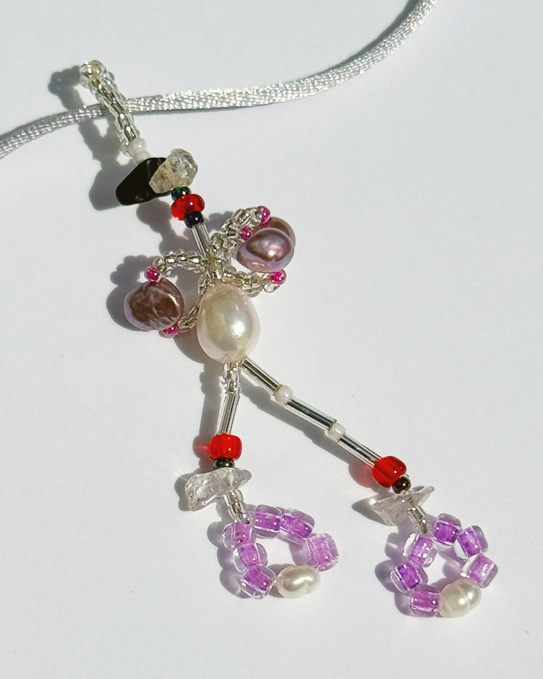 Necklace with colorful beaded pendant on a white background