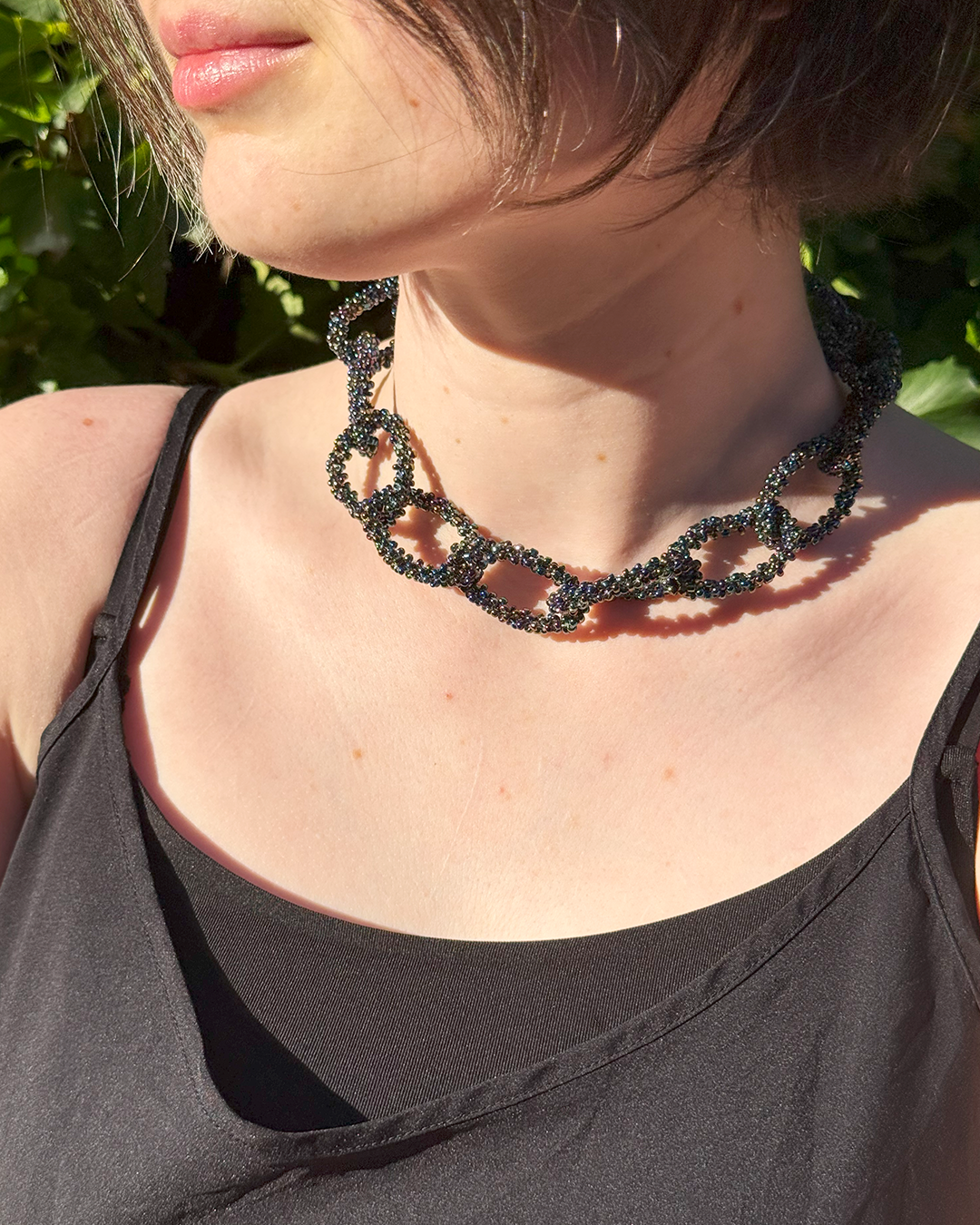 Black Rainbow necklace on a person