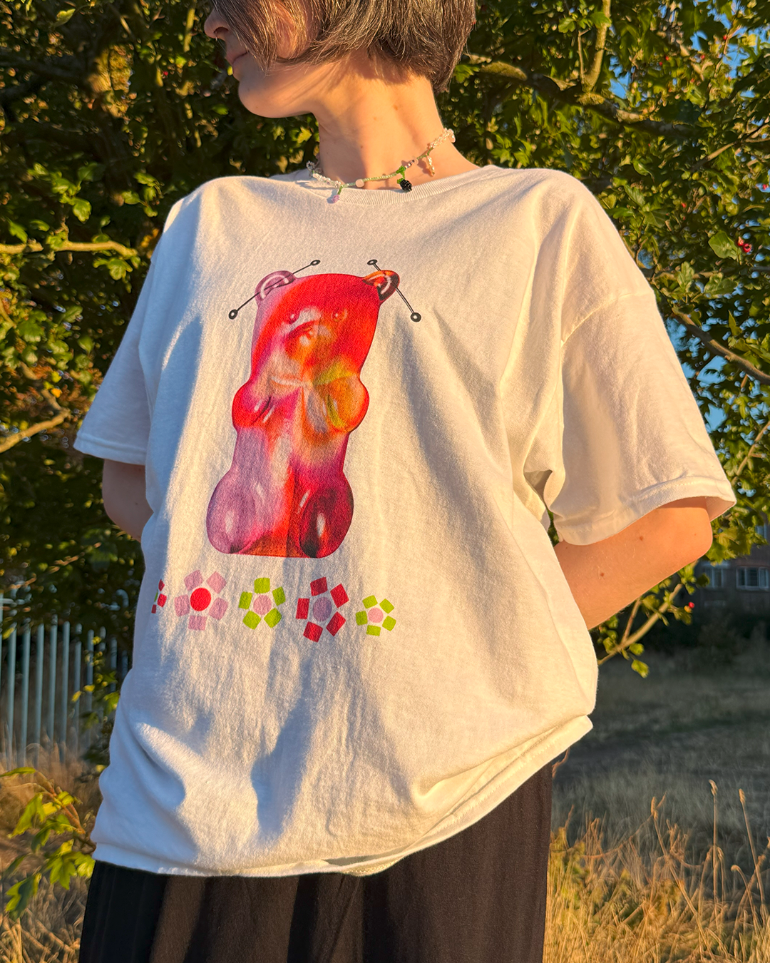 White t-shirt with a gummy bear and beaded flowers