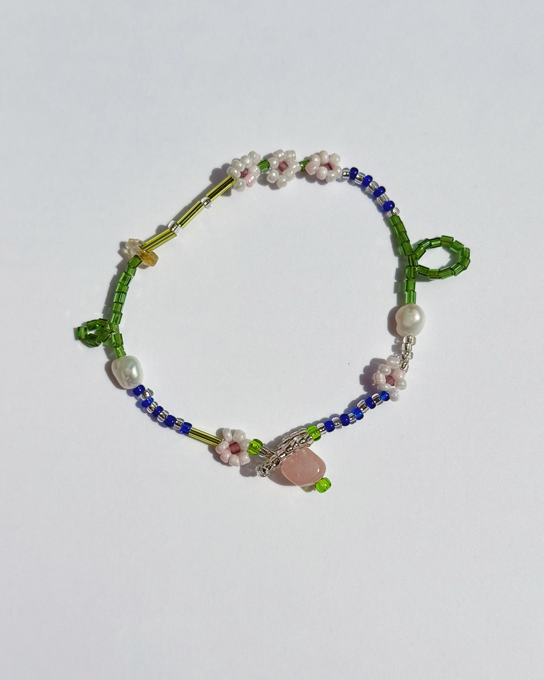 Beaded bracelet with floral designs on a white background